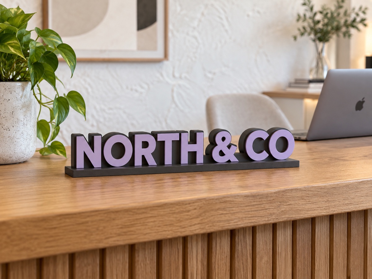 A NORTH & CO business sign on a modern reception desk